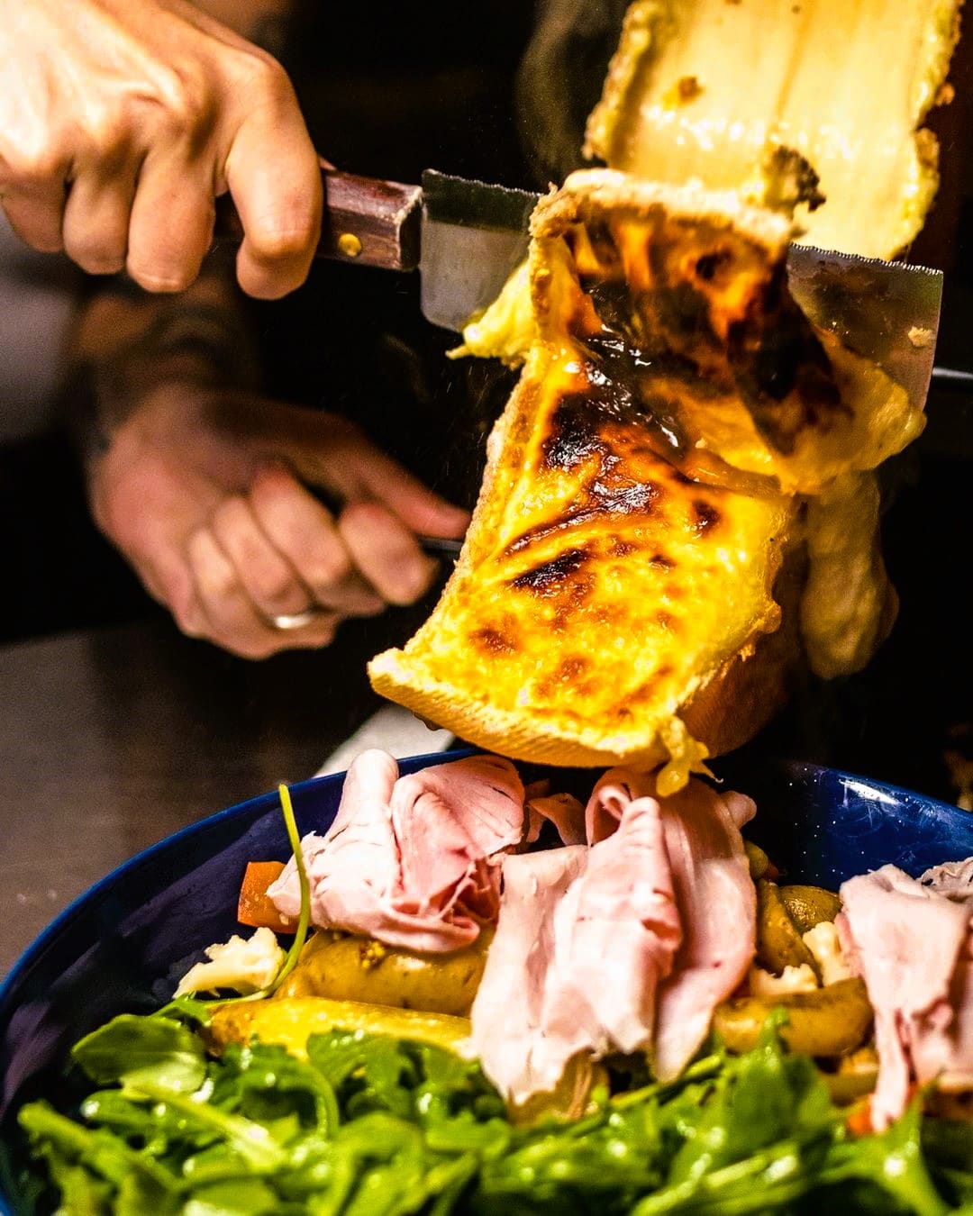 Raclette cheese onto food 63