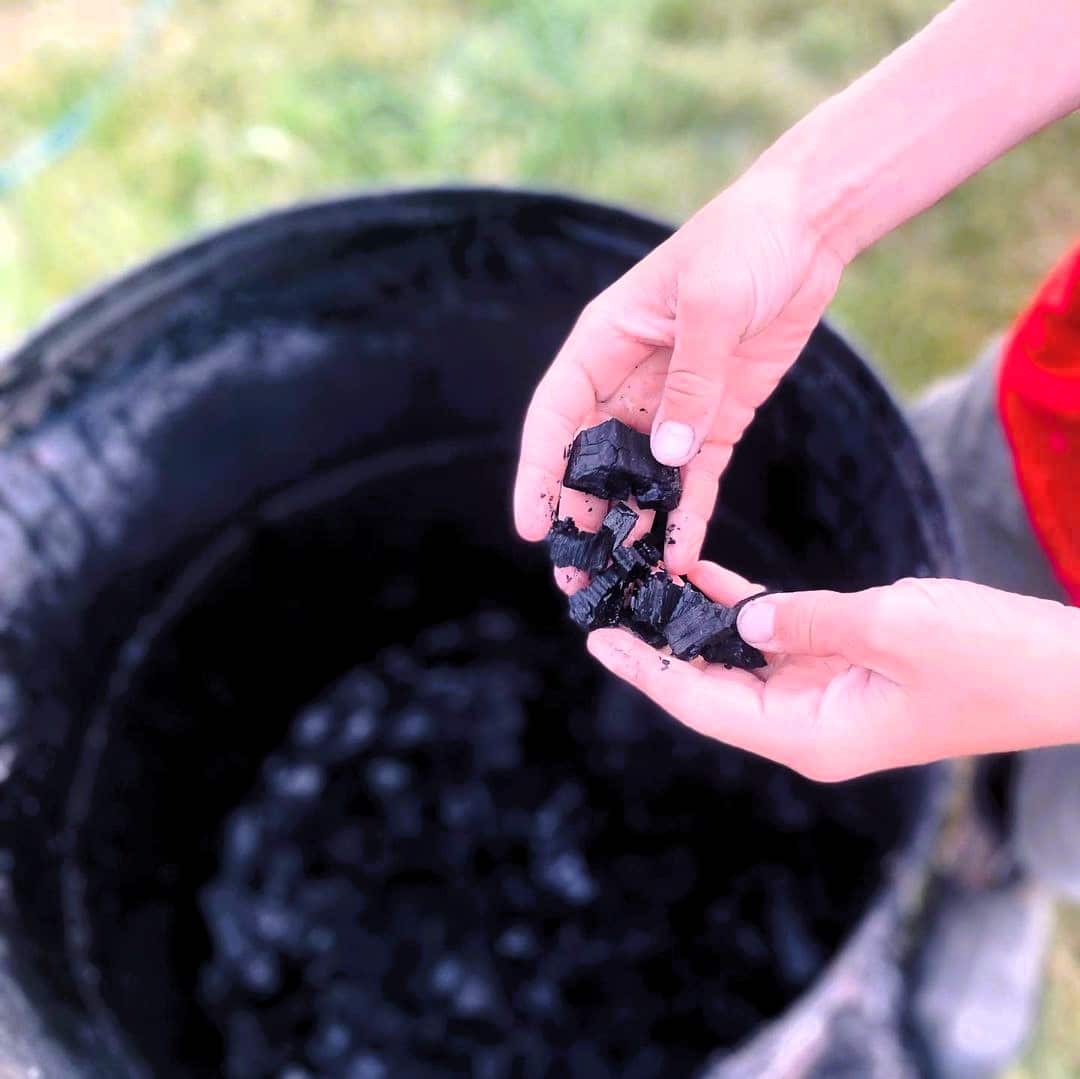 A person holding biochar 726