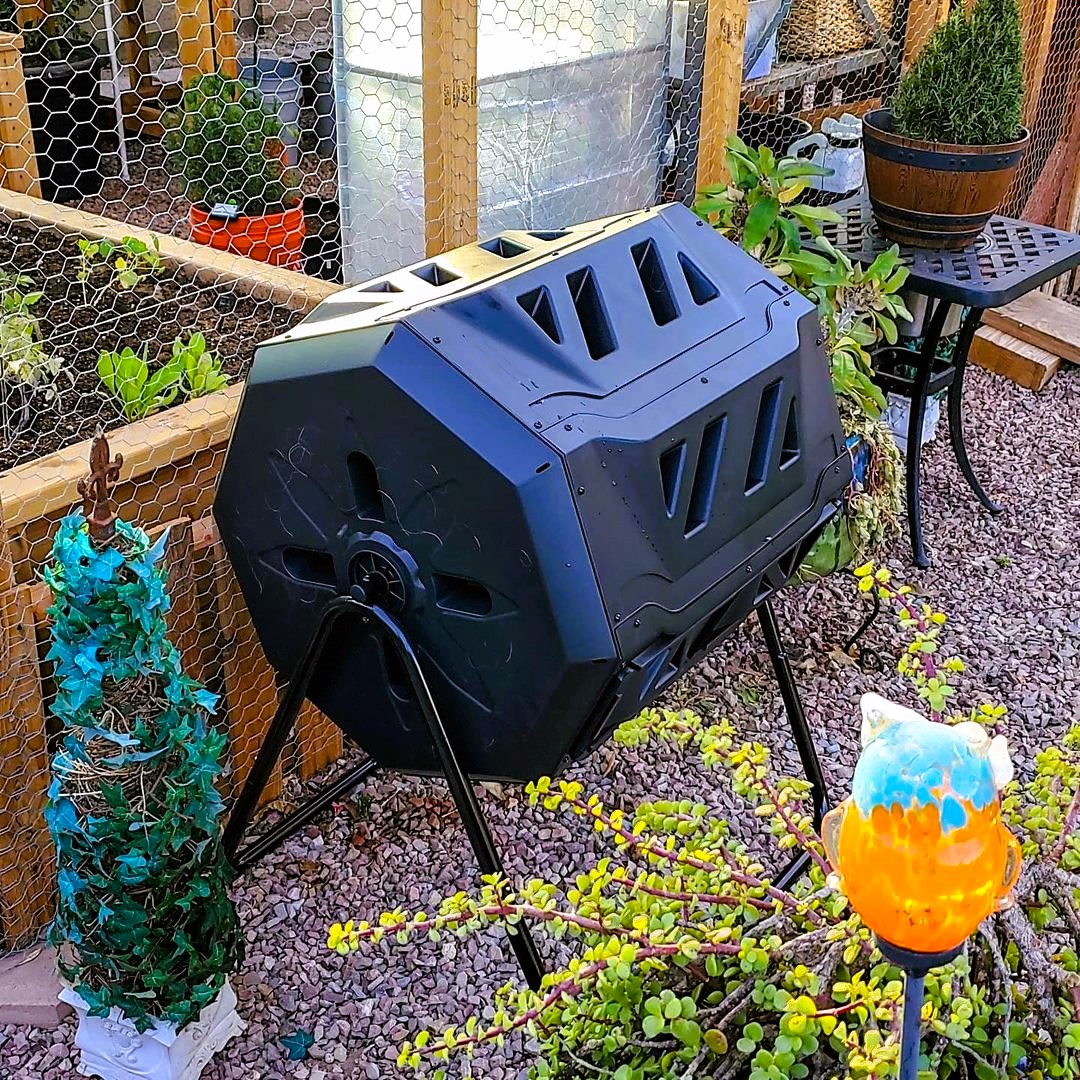 Compost tumbler outside the wooden planter 754